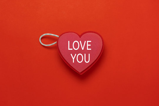 Table top view image of decoration valentine's day holiday background concept.Flat lay essential object sign of heart shape with love you word for season on red paper at office desk studio.