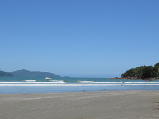 Sea, sand, mountains, sun and blue sky. Beach in the city of Ubatuba. Interior of São Paulo. Brazil.