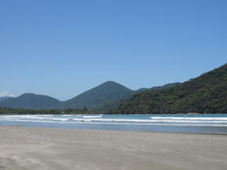 Sea, sand, mountains, sun and blue sky. Beach in the city of Ubatuba. Interior of São Paulo. Brazil.