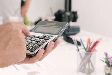 businessman working in office with using a calculator to calculate the numbers, finance accounting concept