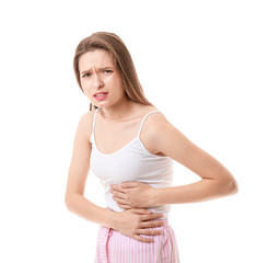 Young woman suffering from stomachache on white background