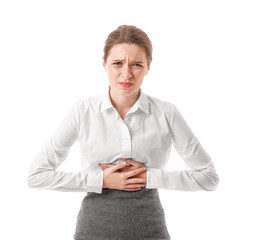 Young businesswoman suffering from abdominal pain on white background