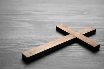 Christian cross on wooden background