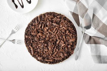 Tasty chocolate cheesecake on white table