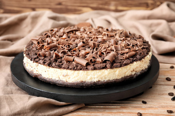 Tasty chocolate cheesecake on wooden table