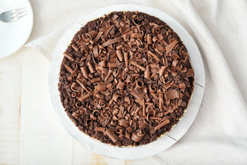 Tasty chocolate cheesecake on white table