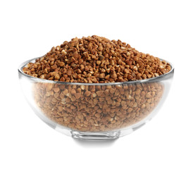 Bowl with raw buckwheat on white background