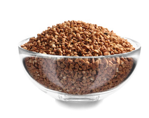 Bowl with raw buckwheat on white background