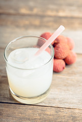 Old fahioned lychee cocktail on the rustic background. Selective focus. Shallow depth of field.