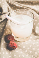 Old fahioned lychee cocktail on the rustic background. Selective focus. Shallow depth of field.