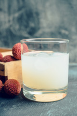 Old fahioned lychee cocktail on the rustic background. Selective focus. Shallow depth of field.