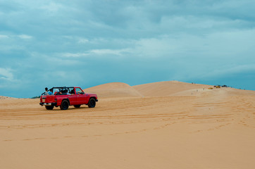 off road car vehicle in white sand dune desert at Mui Ne, Vietnam