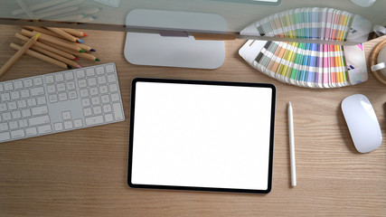 Overhead shot of designer workspace with computer and office supplies on modern rustic desk