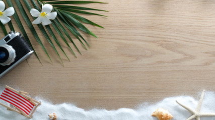 Top view of copy space travel concept with camera, sand and  beach concept decorations