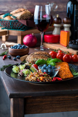 Close up of the edge of a table with a Mediterranean meal on top. Mediterranean cuisine concept.