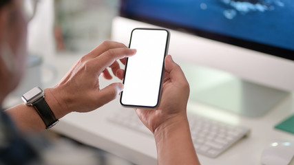 Close-up view of businessman using blank screen smartphone