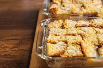 Bread pudding in glass container on wood texture surface table top background.