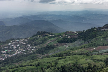 Road curve on mountain and village, Aerial View.