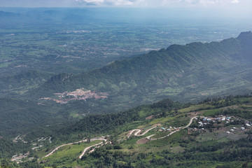 Fototapeta premium Road curve on mountain and village, Aerial View.