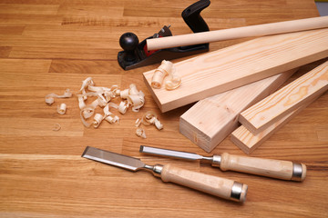  Carpenter's workbench planks, tools  and wood shavings.   Woodworking and carpentry concept.