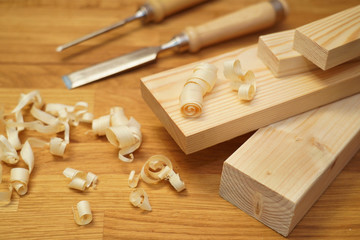  Carpenter's workbench planks, tools  and wood shavings.   Woodworking and carpentry concept.
