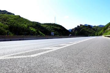 Fototapeta na wymiar Empty highway, blue sky and white clouds landscape