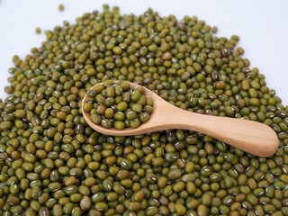 Above of green mung beans in woosen spoon.