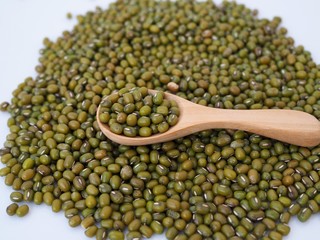 Above of green mung beans in woosen spoon.
