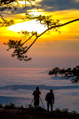 Fototapeta na wymiar silhouette of man at sunrise on top mountain