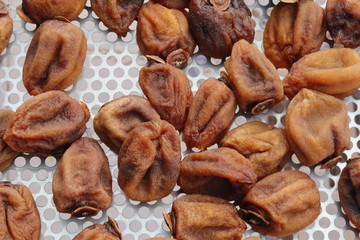 Hanging persimmon - Japanese Dried Persimmon (Hoshigaki) hanged on strings to dry a common sight