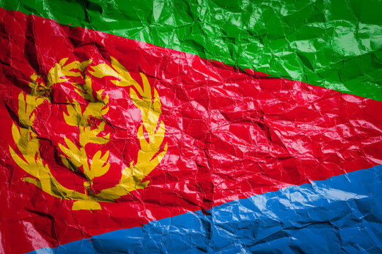 National flag of Eritrea on crumpled paper. Flag printed on a sheet. Flag image for design on flyers, advertising.