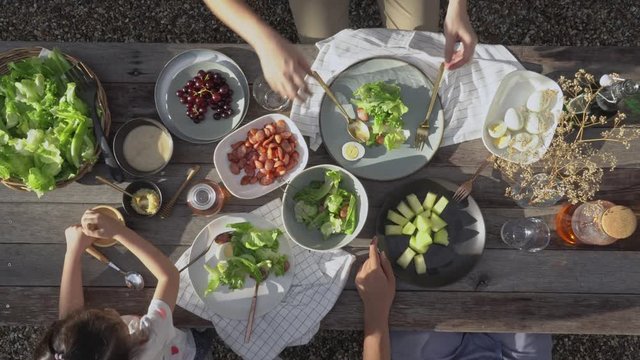Family dinner with organic salad on rustic wooden table, Food healthy organic vegetable concept with top view