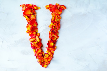 The letter of the English alphabet is lined with rose petals