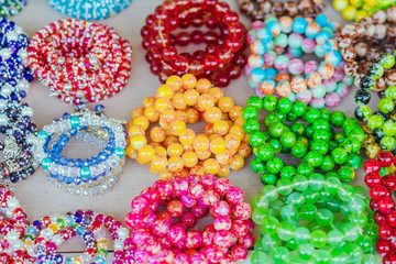 The colorful stone is used to make beautiful bracelets. Is a religious belief of Thai people that will have good luck for sale on the local market in Kanchanaburi, Thailand. Selective focus.