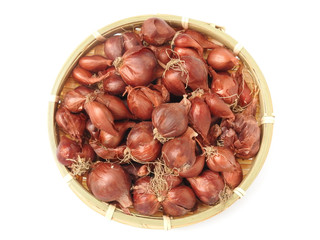 Top view of natural organic fresh raw red shallot onion on bamboo basket  isolated on white background.Taiwan's red onion is water droplets type,skin is red. For cook. Food and vegetable concept.