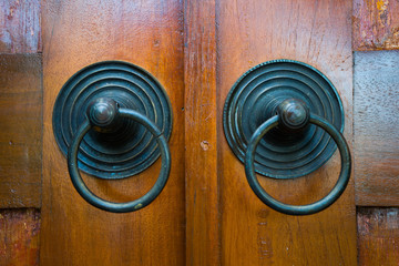 Fototapeta premium Round old wooden door handle made of brass. 