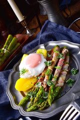 delicious green asparagus wrapped in bacon and egg