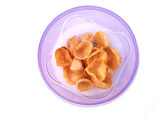 some yellow eatable food put in blue plastic bowl isolated on white background