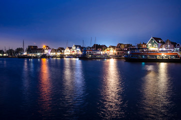 Fototapeta na wymiar Dutch village at night, beautiful reflection in water, Volendam, Netherlands