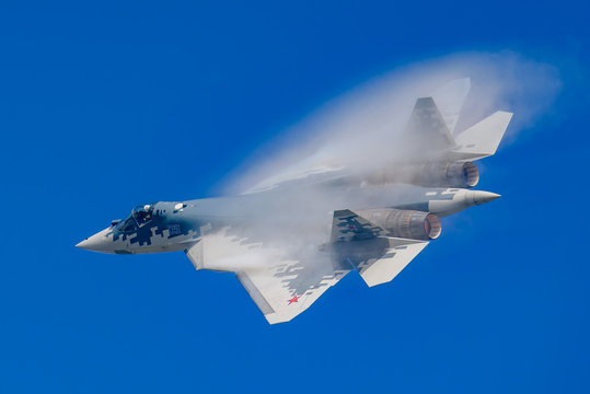 Jhukovsky, Ramenskoye airfield - August 2019: Russian 5th generation jet fighter Sukhoi Su-57 (PAK-FA, T-50) with condensation cloud of Prandtl–Glauert singularity.