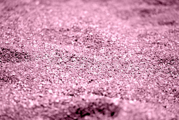 Coastal sand texture close-up. Natural background pink color toned