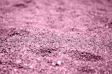 Coastal sand texture close-up. Natural background pink color toned