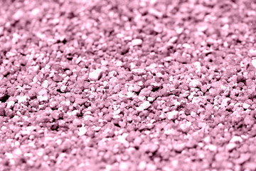 Coastal sand texture close-up. Natural background pink color toned