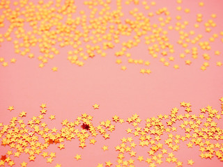 Golden stars glitter on pink background