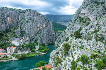 View of Cetina River, mountains and old town Omis, Croatia. Cetina river canyon and mouth in Omis view from above, Dalmatia region of Croatia