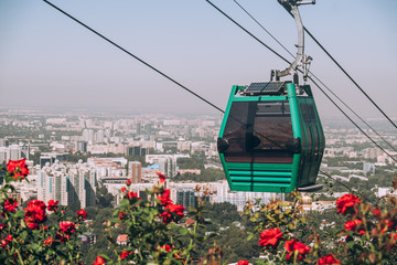 Kazakhstan, Almaty City view. A cable car cabin rises in the foreground