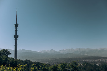 Kazakhstan. View of the city of Almaty. Summer, sunny weather. Tall buildings on a background of mountains