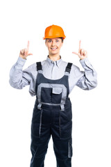 Female builder looks at the camera and shows with both hands up. Isolated