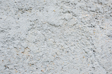 gray concrete wall, stucco, rough stone, with holes and irregularities