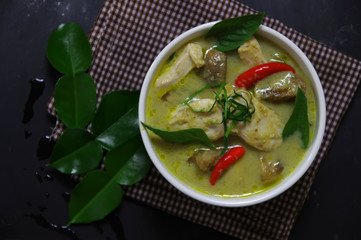 The green curry serving in white bowl